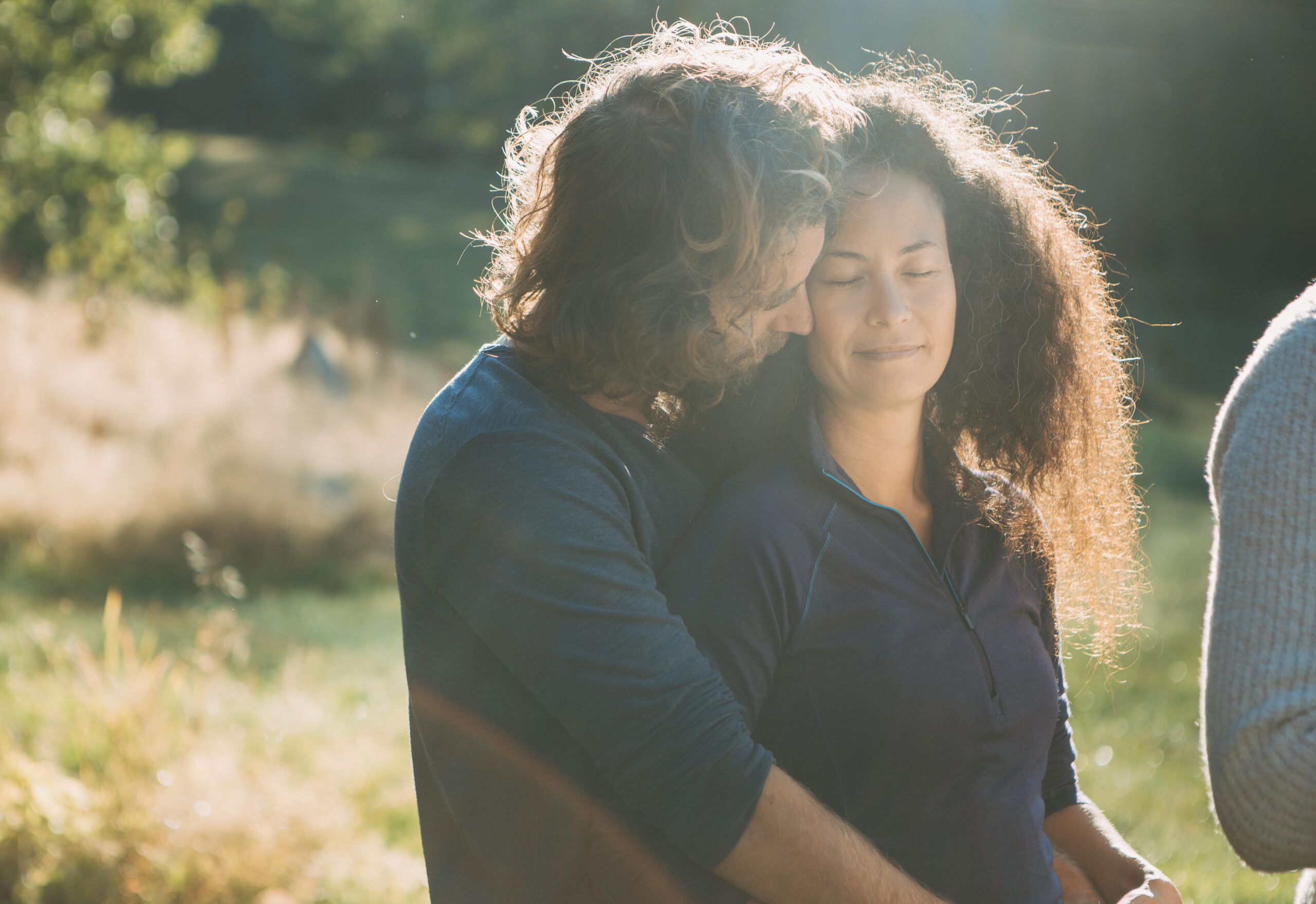A man hugging a woman from behind